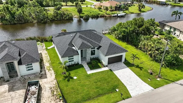 an aerial view of a house with a lake view