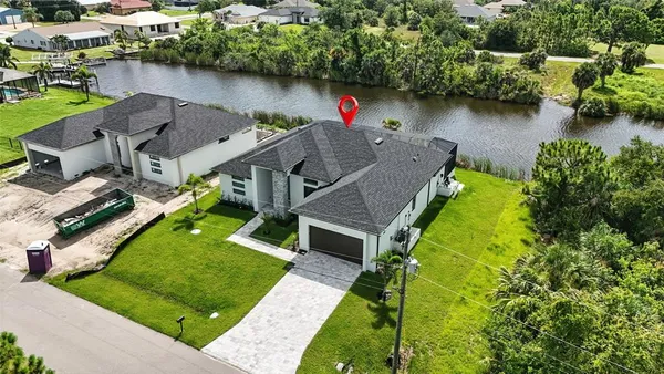 an aerial view of a house with a lake view