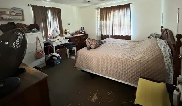 a bedroom with bed and window