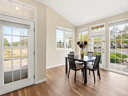 a view of a dining room with furniture and wooden floor