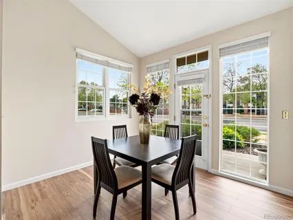a dining room with furniture window and wooden floor