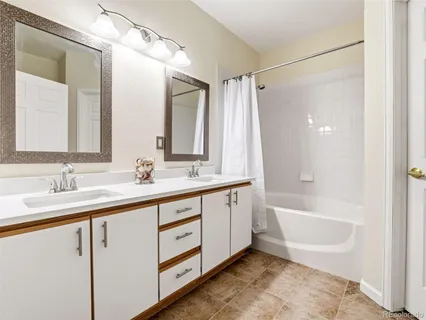 a bathroom with a tub sink and mirror