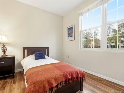 a bed sitting in a bedroom next to a window