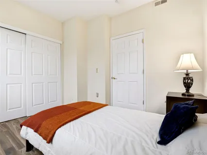 a bedroom with a bed and a lamp