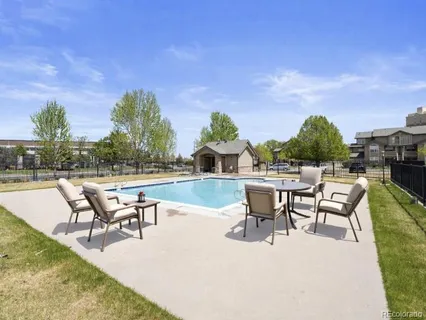 a swimming pool with outdoor seating and yard