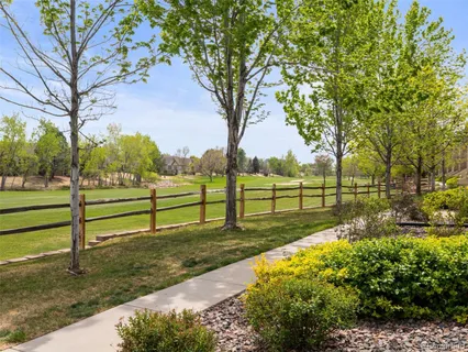 a view of backyard with wooden fence