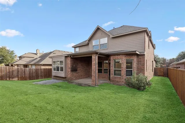 a view of a house with a yard and porch