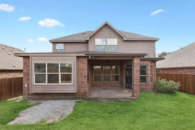 a front view of a house with a yard and porch