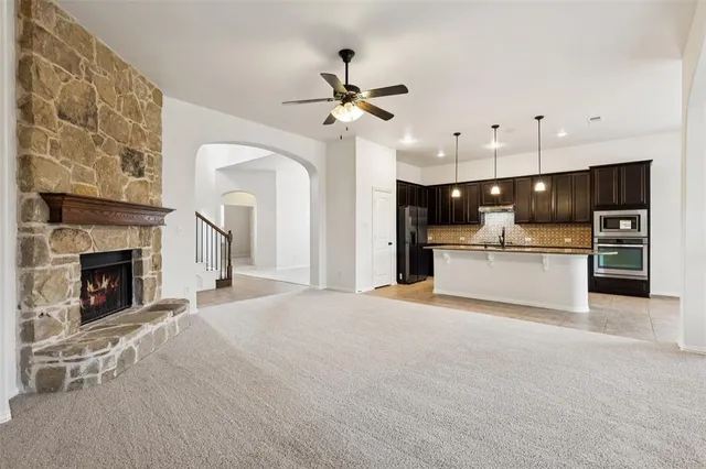 a view of a kitchen with a sink and a fireplace