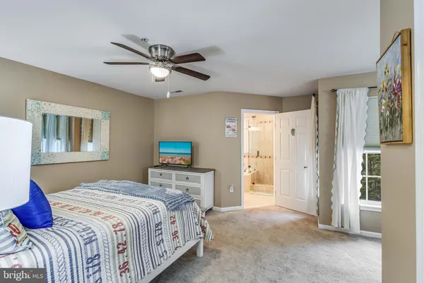a living room with a bed and a chandelier