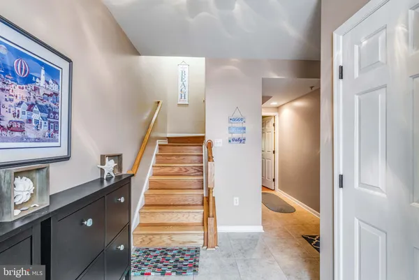 a large bedroom with a bed and wooden floor