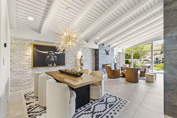 a living room with furniture and a floor to ceiling window