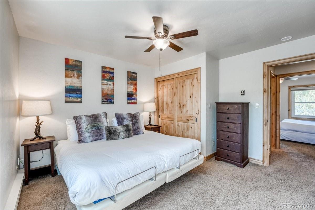 200 North Ridge Street, Unit R1 Breckenridge, CO 80424 - Photo 24 of 27 a bedroom with a bed and a chandelier