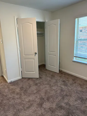 an empty room with closet area
