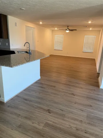 a kitchen with granite countertop a sink and a stove