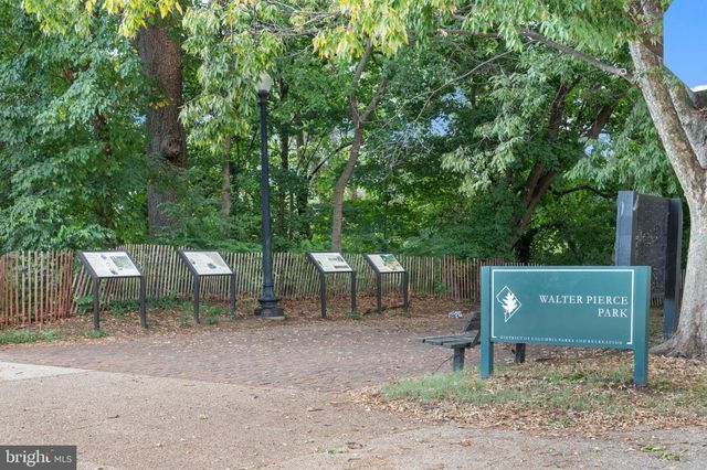 a street sign on a sidewalk next to a road
