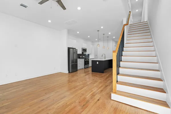 a view of kitchen and hall with wooden floor