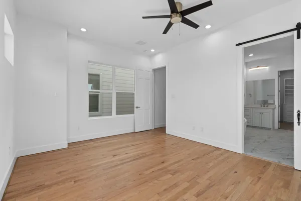 a view of a livingroom with a ceiling fan and window