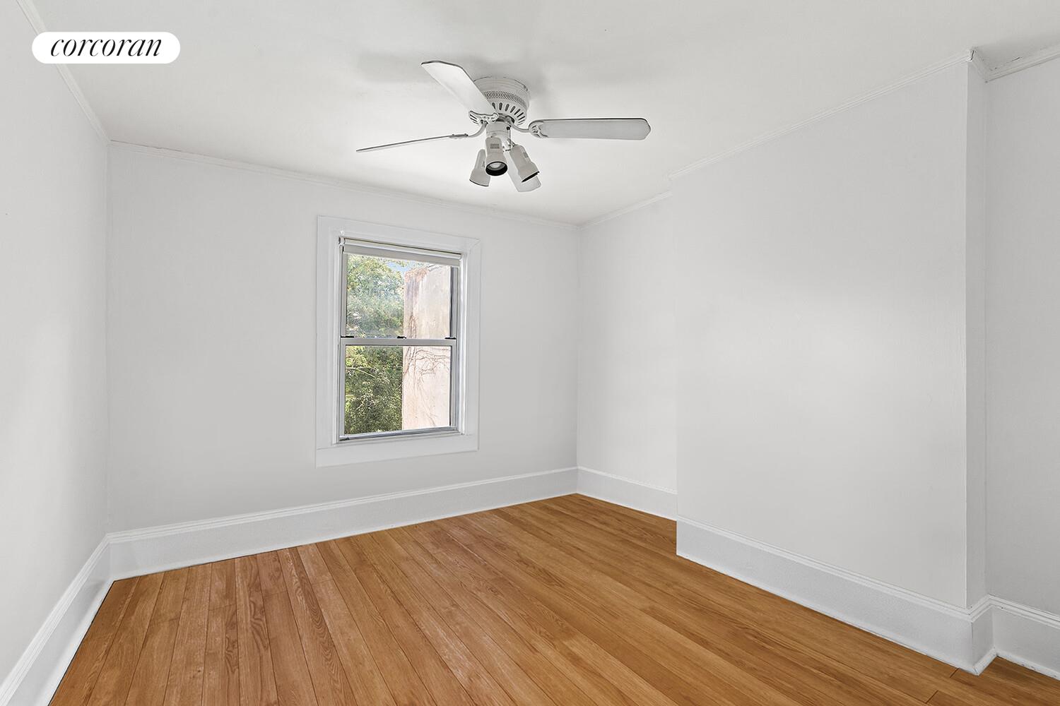 459 Union Street Brooklyn, NY 11231 - Photo 8 of 13 an empty room with wooden floor fan and windows