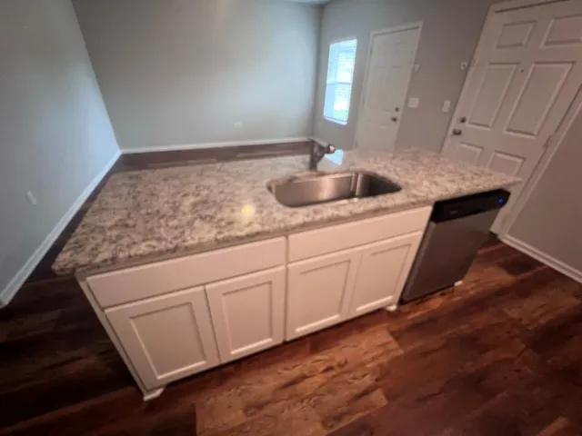 a view of a backyard with wooden fence