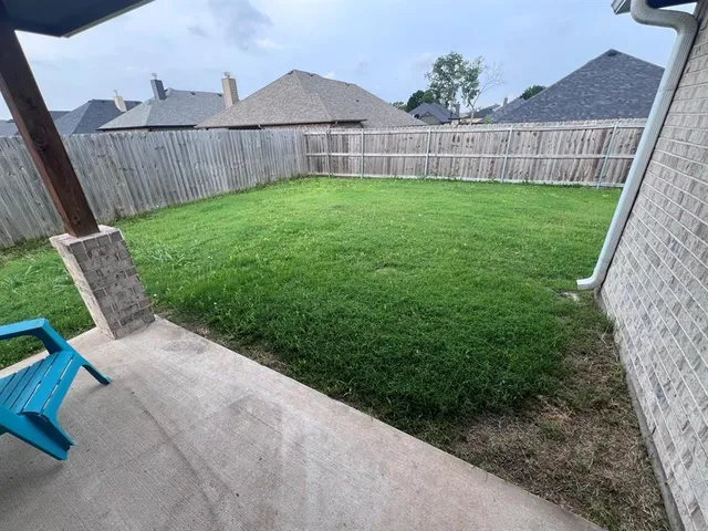 a view of a yard with an outdoor seating