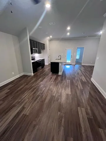 a view of kitchen with sink and refrigerator