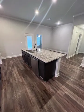 a view of an empty room and wooden floor