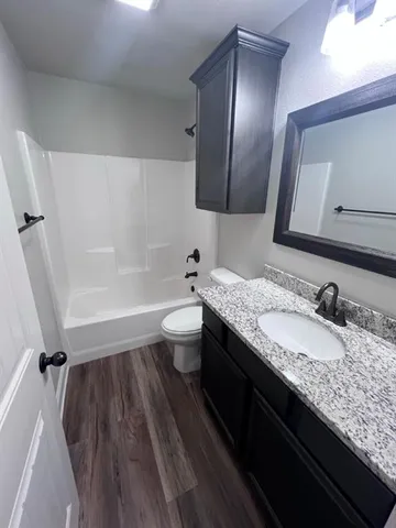 a view of a livingroom with a ceiling fan and window