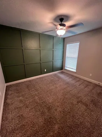 a view of room with a ceiling fan