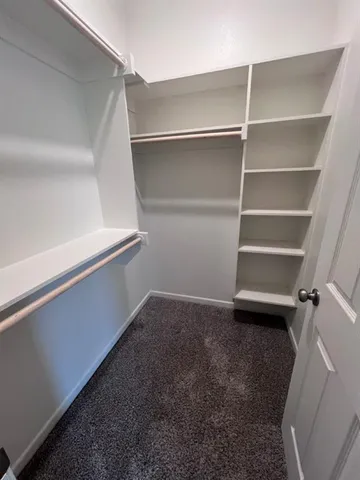 a view of an empty walk in closet