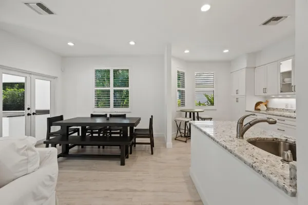 a kitchen with stainless steel appliances granite countertop a sink a stove and a refrigerator