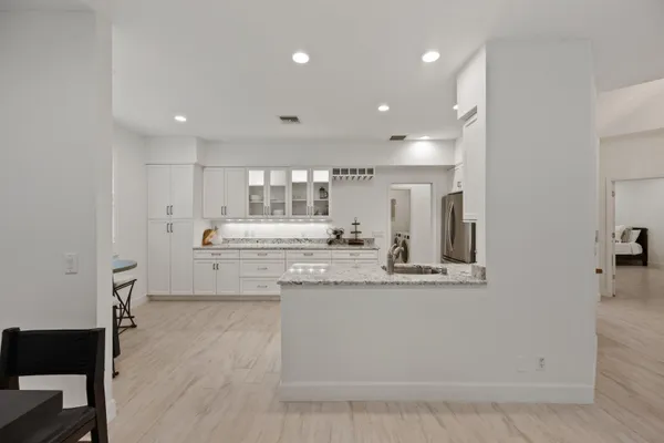 a kitchen with stainless steel appliances granite countertop a stove a sink and a refrigerator