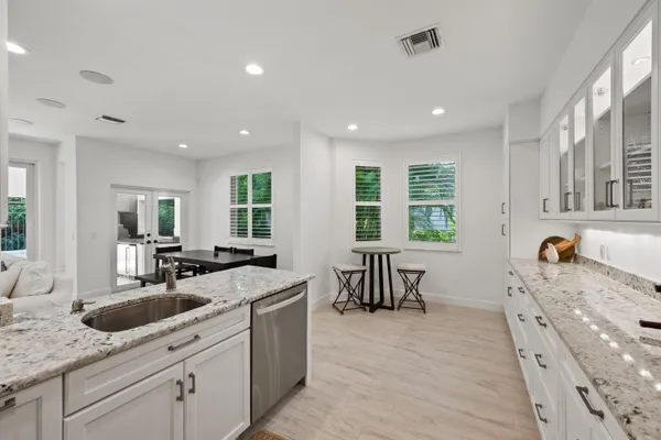 a kitchen with sink stove and cabinets