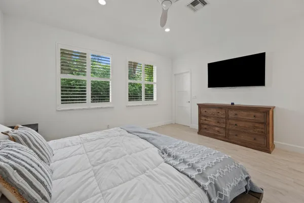 a bedroom with a bed and a television