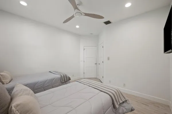 a bedroom with a bed and a flat screen tv