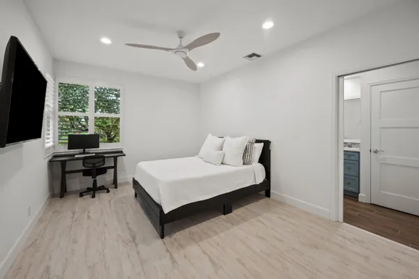 a bedroom with a bed and a flat screen tv