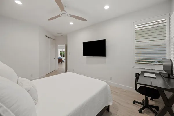 a bedroom with a bed and a flat screen tv