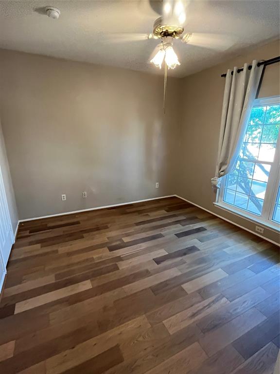 2524 Preston Road, Unit 404 Plano, TX 75093 - Photo 8 of 9 a view of an empty room with wooden floor and a window