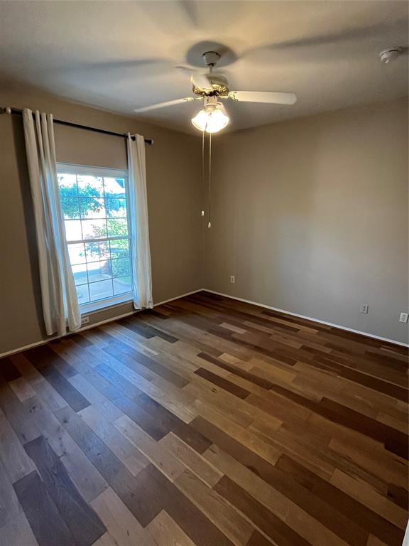 2524 Preston Road, Unit 404 Plano, TX 75093 - Photo 9 of 9 a view of an empty room with wooden floor and a window