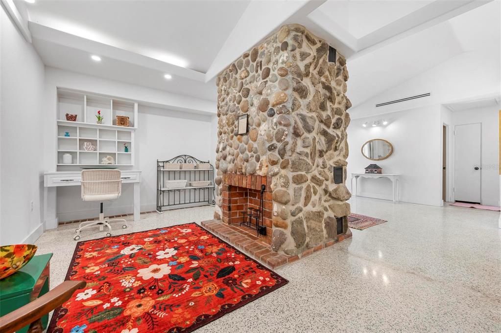 528 45th Street Sarasota, FL 34234 - Photo 17 of 45 wooden floor in an empty room with a rug and a fireplace