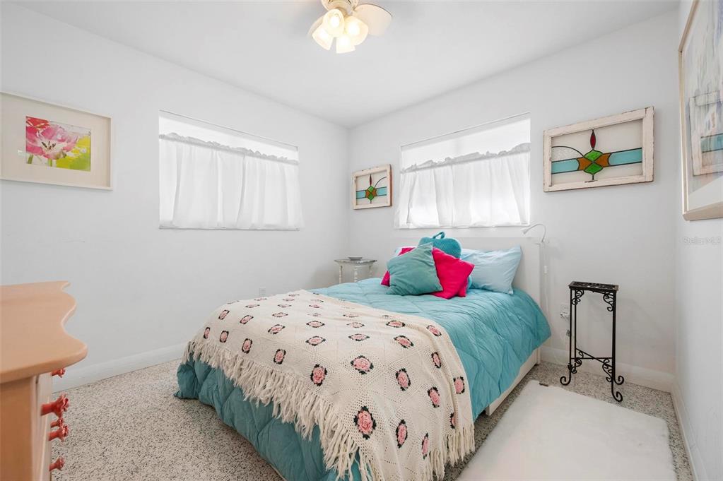 528 45th Street Sarasota, FL 34234 - Photo 20 of 45 a bedroom with a bed and a chandelier