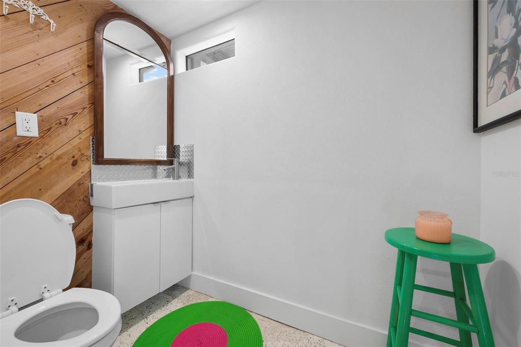 528 45th Street Sarasota, FL 34234 - Photo 23 of 45 a bathroom with a toilet mirror vanity and a sink