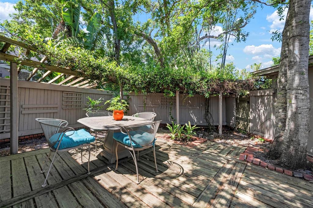 528 45th Street Sarasota, FL 34234 - Photo 25 of 45 a backyard of a house with table and chairs