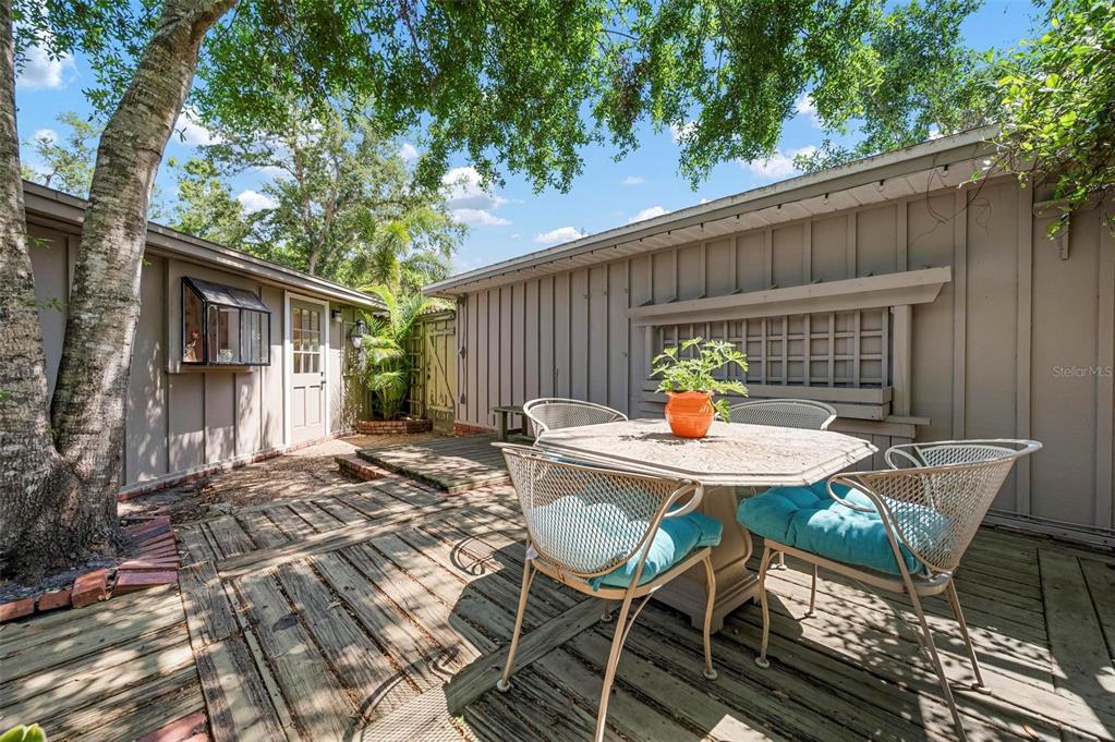 528 45th Street Sarasota, FL 34234 - Photo 26 of 45 a backyard of a house with table and chairs