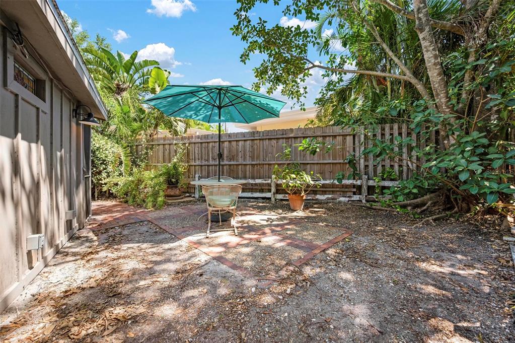 528 45th Street Sarasota, FL 34234 - Photo 44 of 45 a view of a patio with a table and chairs under an umbrella