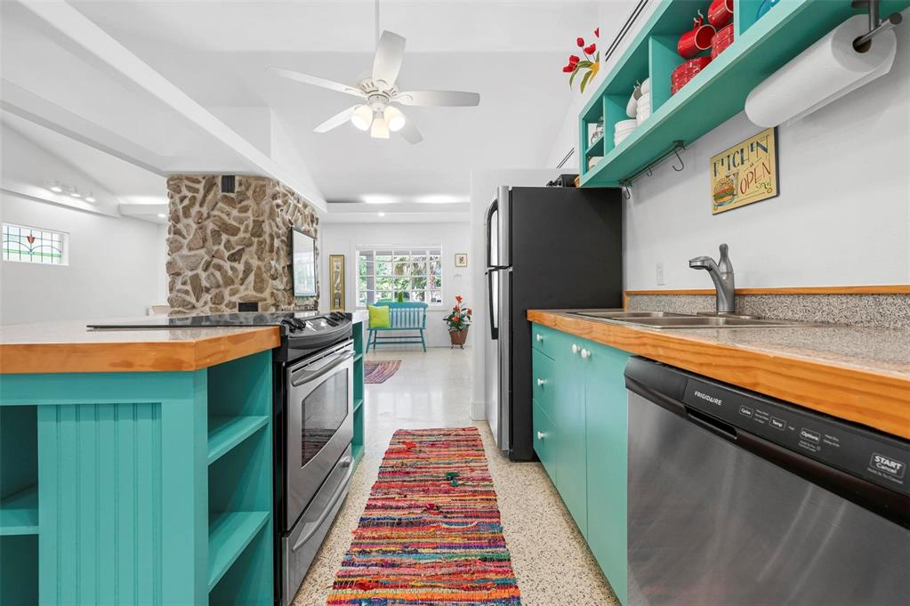 528 45th Street Sarasota, FL 34234 - Photo 8 of 45 a kitchen with stainless steel appliances granite countertop a refrigerator a sink dishwasher with a dining table and chairs