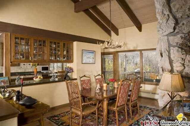 205 Glen Eagle Drive Aspen, CO 81611 - Photo 2 of 8 a dining room with furniture a chandelier and wooden floor