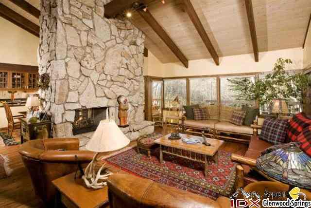205 Glen Eagle Drive Aspen, CO 81611 - Photo 5 of 8 a living room with patio furniture and a fireplace
