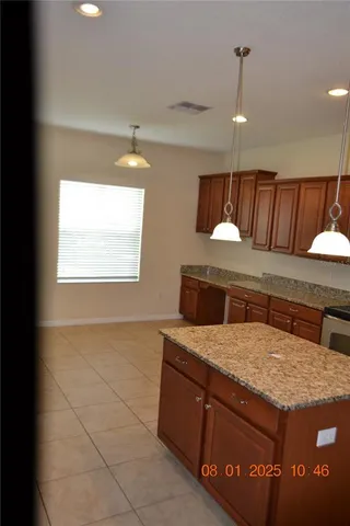 a kitchen with a stove a sink and a window