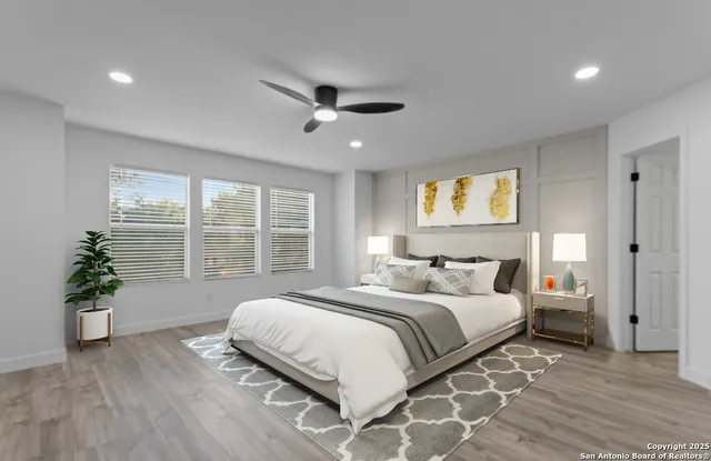 a spacious bedroom with a large bed and a potted plant